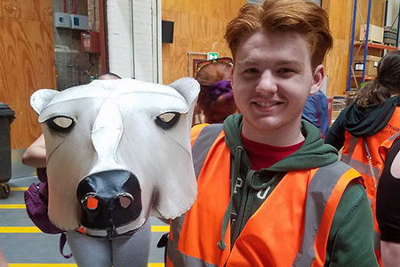 student holds a puppet head in London